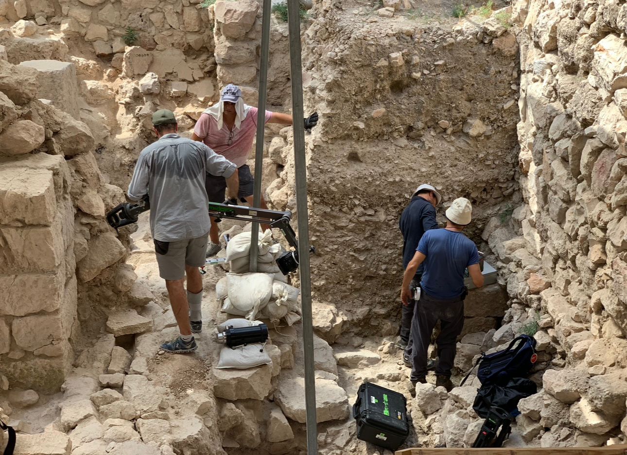 Biblical archaeology filming crew at ancient excavation site documenting historical discoveries for television documentary