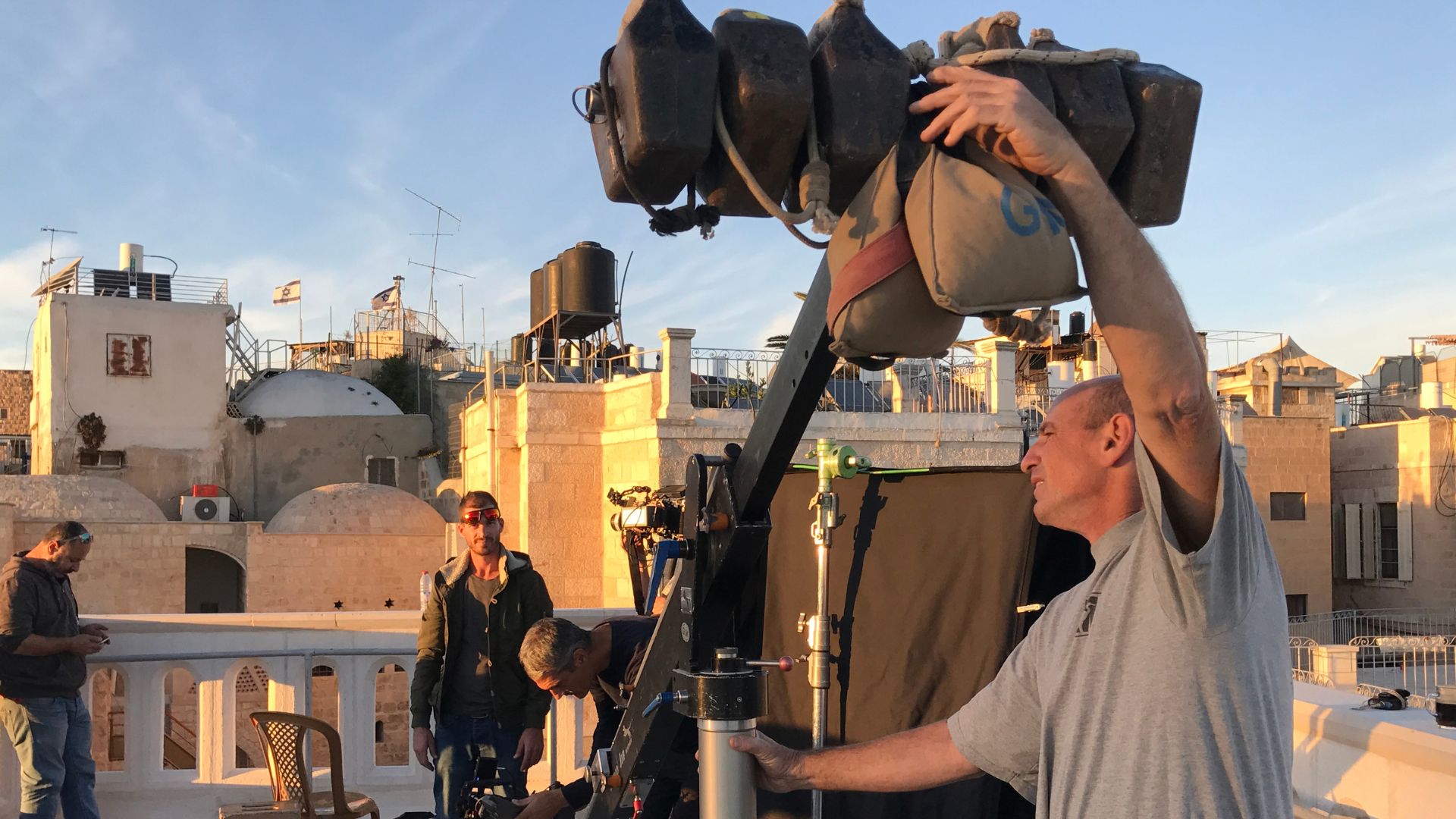 Professional video services Jerusalem - lighting team preparing for on-location filming Jerusalem